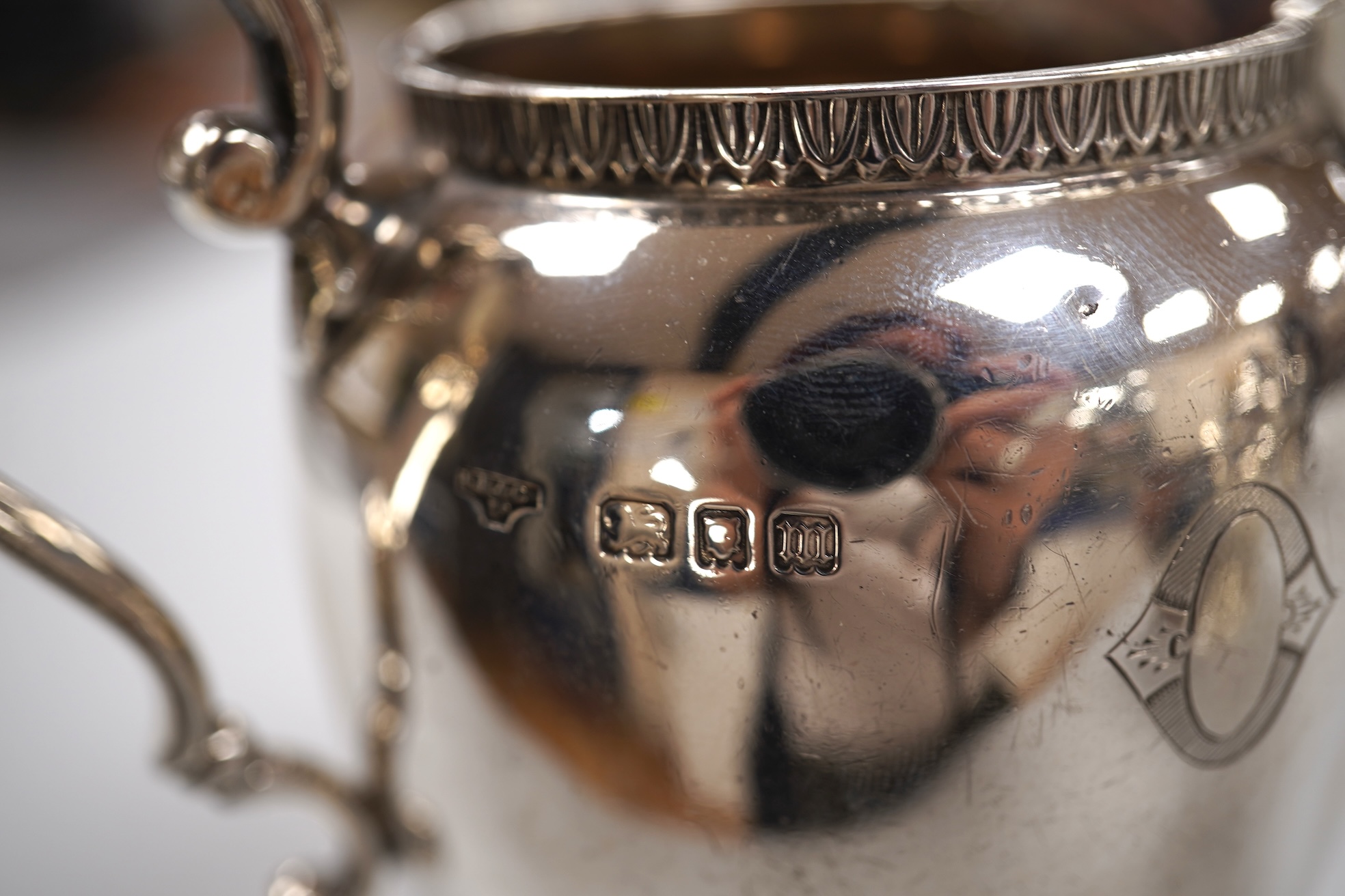 A George V silver circular three piece tea set, with engraved initial, Fenton, Russell & Co Ltd, London, 1927, gross weight 32.4oz.